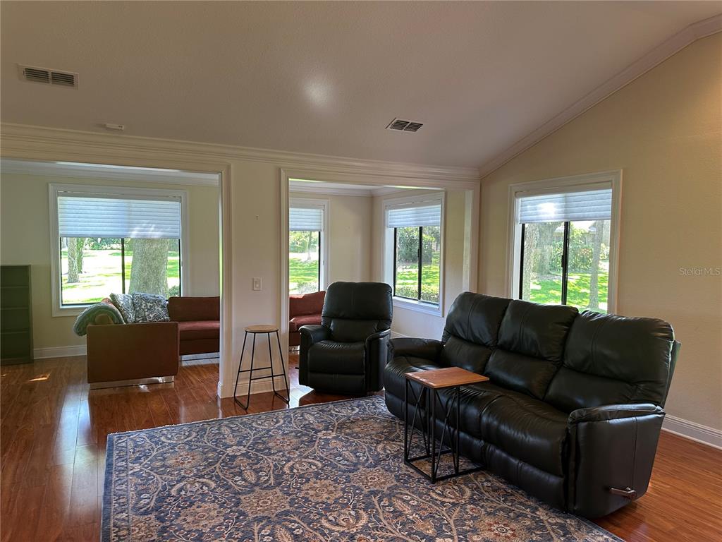 104 Woden Way Winter Haven, FL 33884 - Photo 10 of 48 a living room with furniture and wooden floor