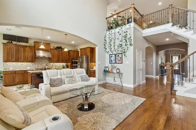 a living room with furniture and a chandelier