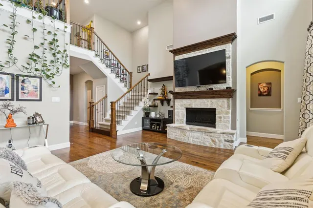 a living room with furniture a flat screen tv and a fireplace