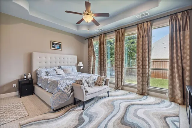 a bedroom with a large bed and a chandelier