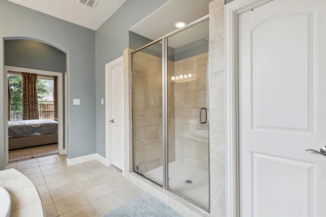 a bathroom with a shower and a tub