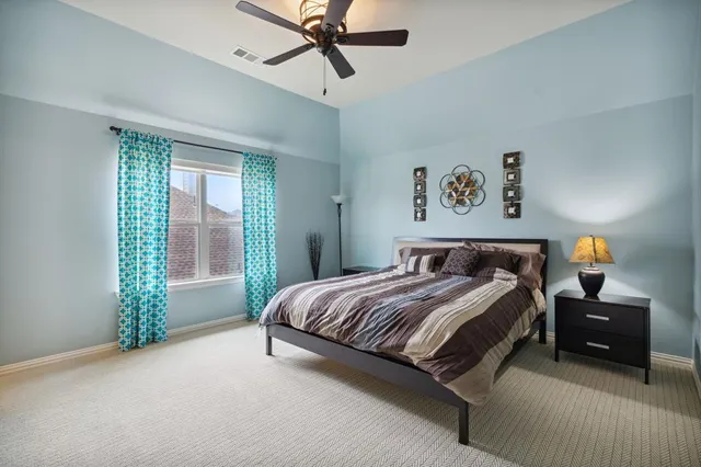 a bedroom with a bed and a window