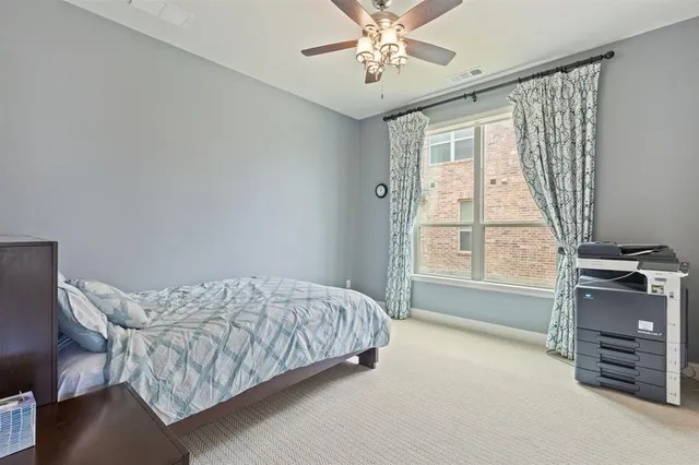 a spacious bedroom with a bed and a window