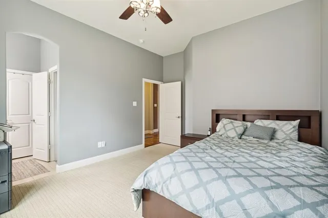 a bedroom with a large bed and a chandelier