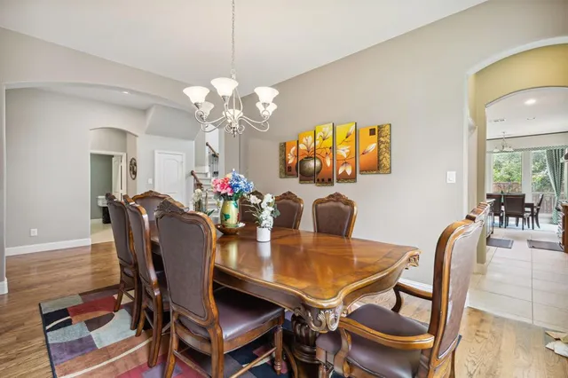 a dining room with furniture and chandelier