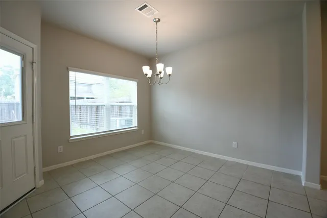 a view of an empty room with windows