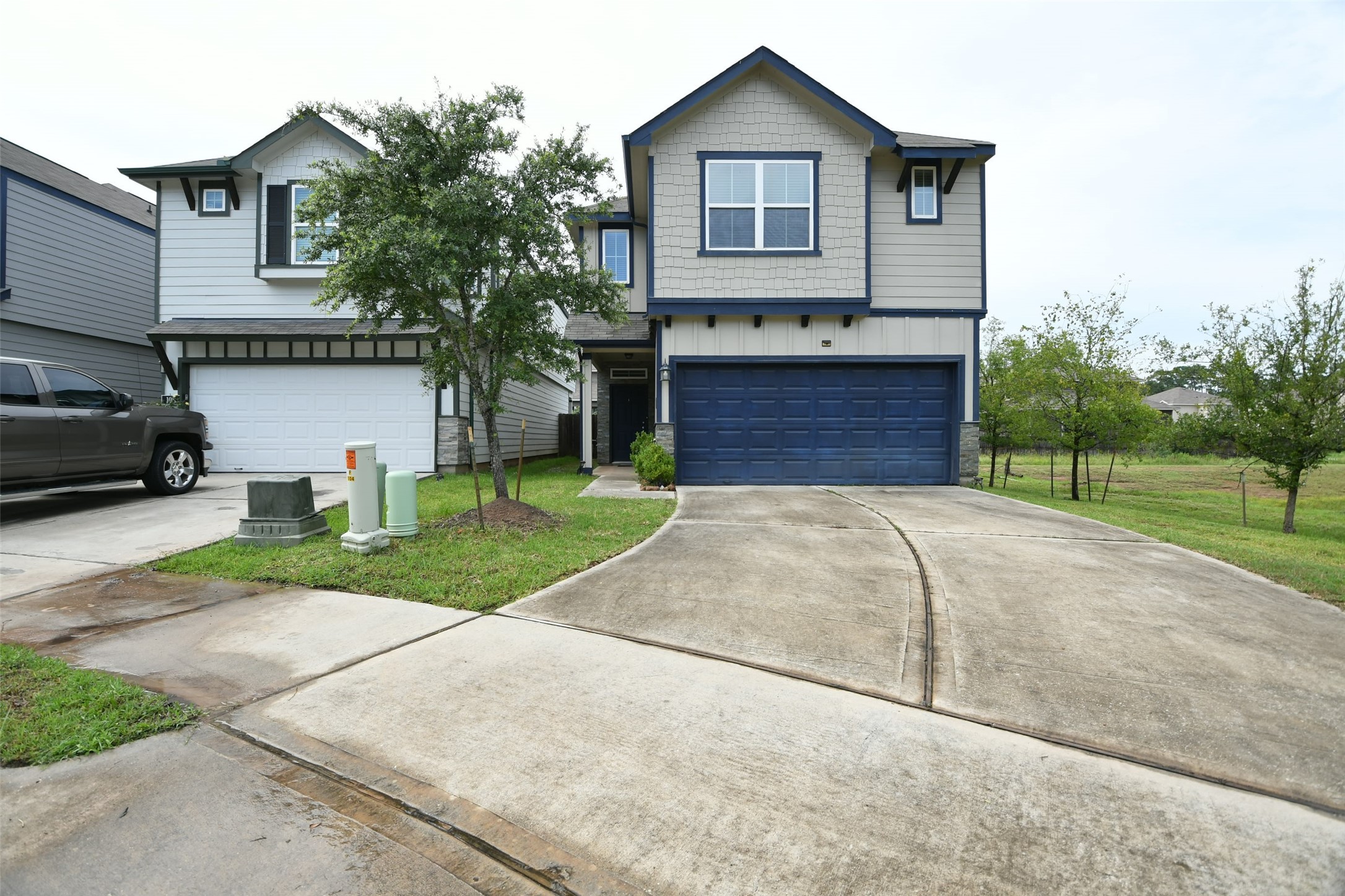 104 Camelot Pl Court Conroe, TX 77304 - Photo 2 of 34 a front view of a house with a yard and garage