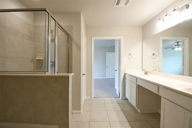 a spacious bathroom with a shower and a sink