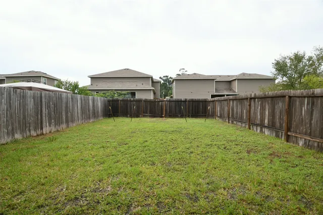 a view of a backyard with large trees