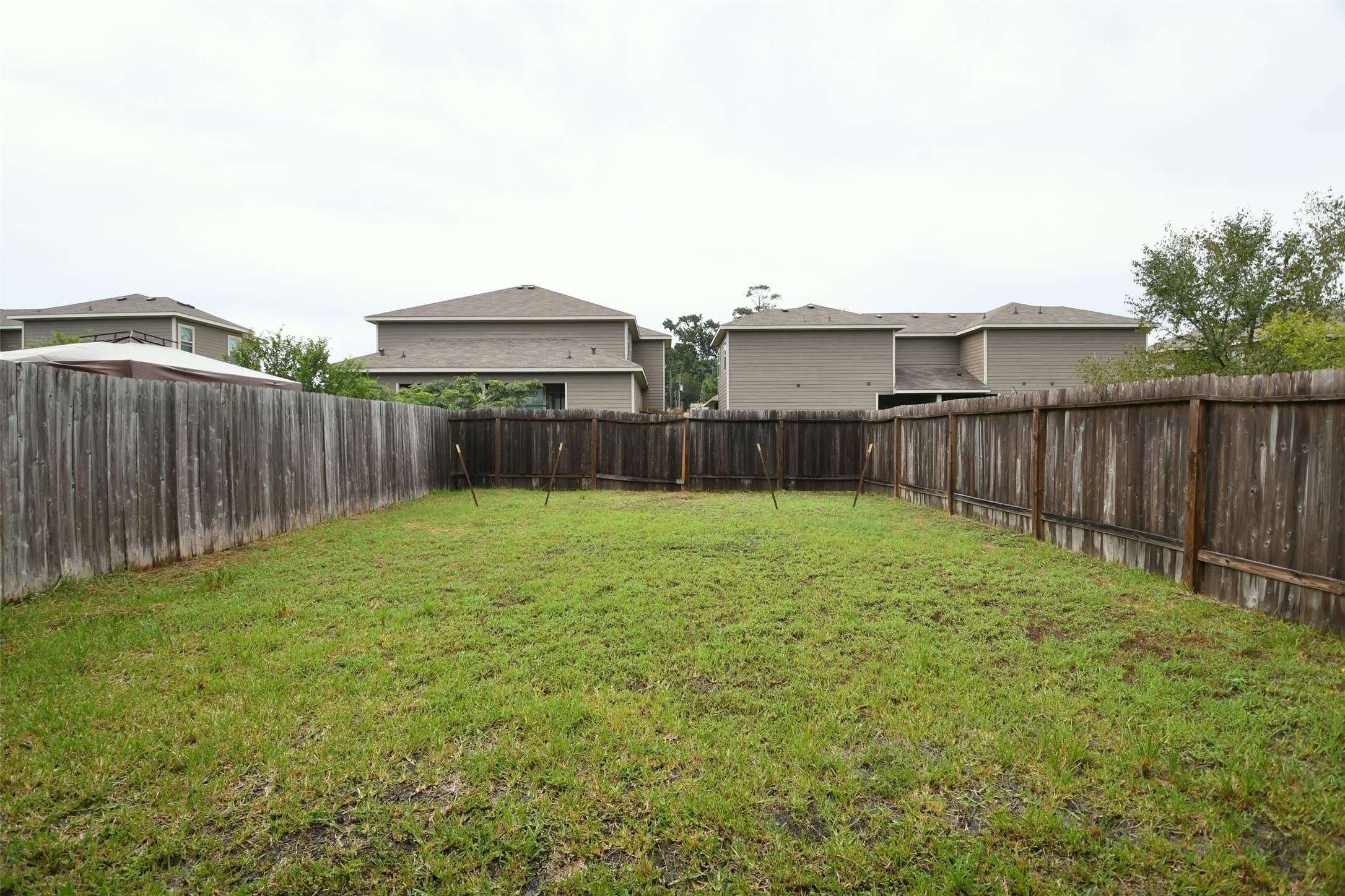 104 Camelot Pl Court Conroe, TX 77304 - Photo 32 of 34 a view of a backyard with large trees