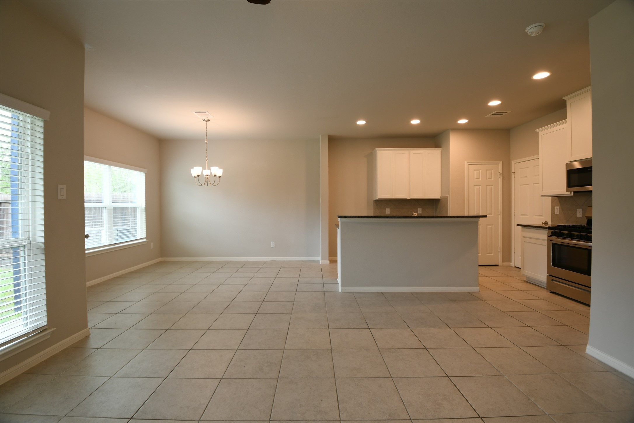 104 Camelot Pl Court Conroe, TX 77304 - Photo 5 of 34 a kitchen with stainless steel appliances granite countertop a stove top oven a sink and a refrigerator