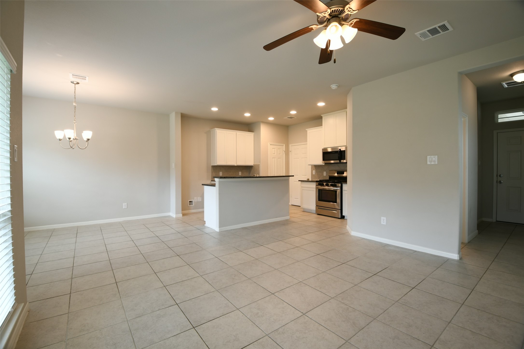 104 Camelot Pl Court Conroe, TX 77304 - Photo 6 of 34 a view of a kitchen with a sink and a refrigerator