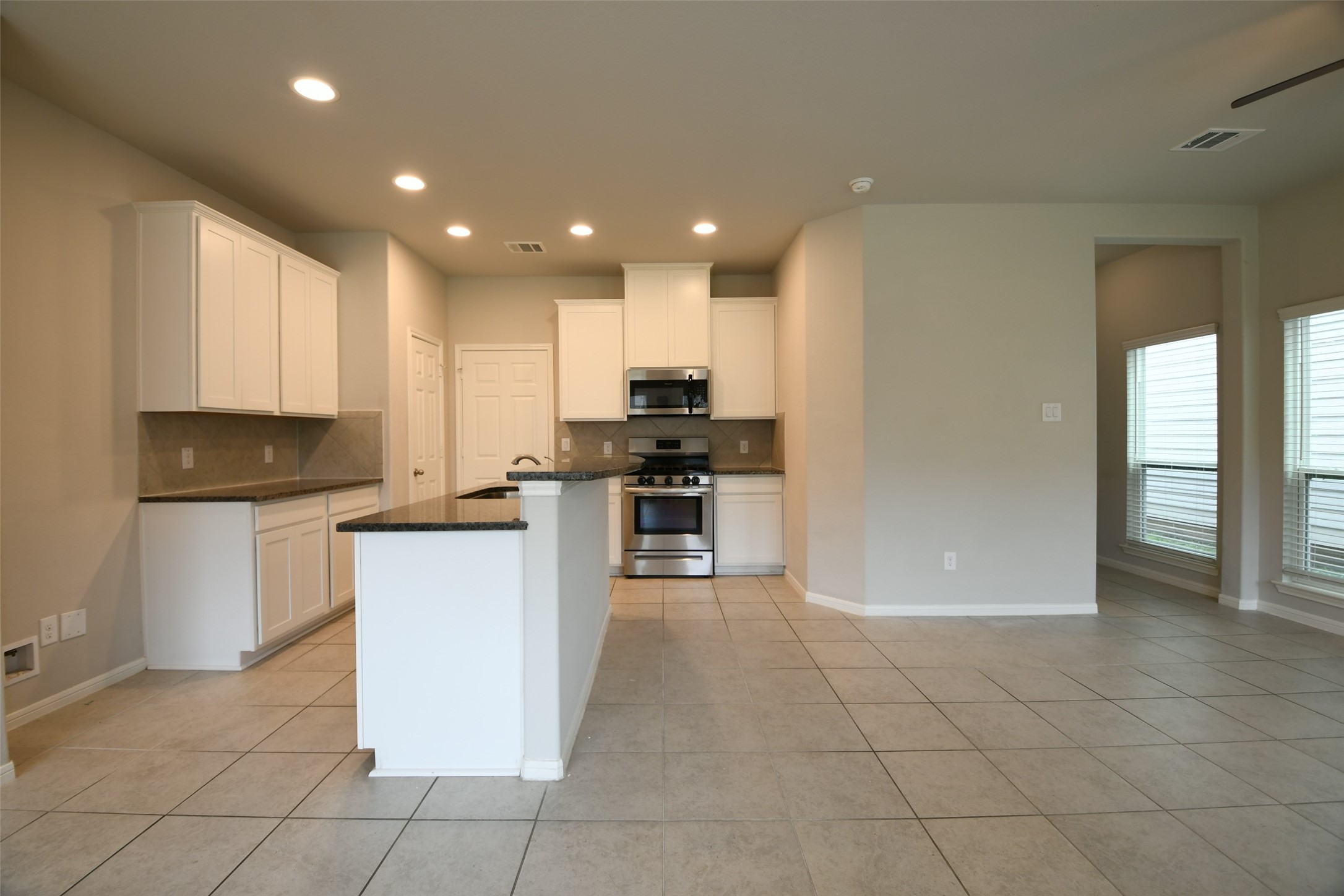 104 Camelot Pl Court Conroe, TX 77304 - Photo 8 of 34 a kitchen with stainless steel appliances granite countertop a refrigerator and a stove top oven