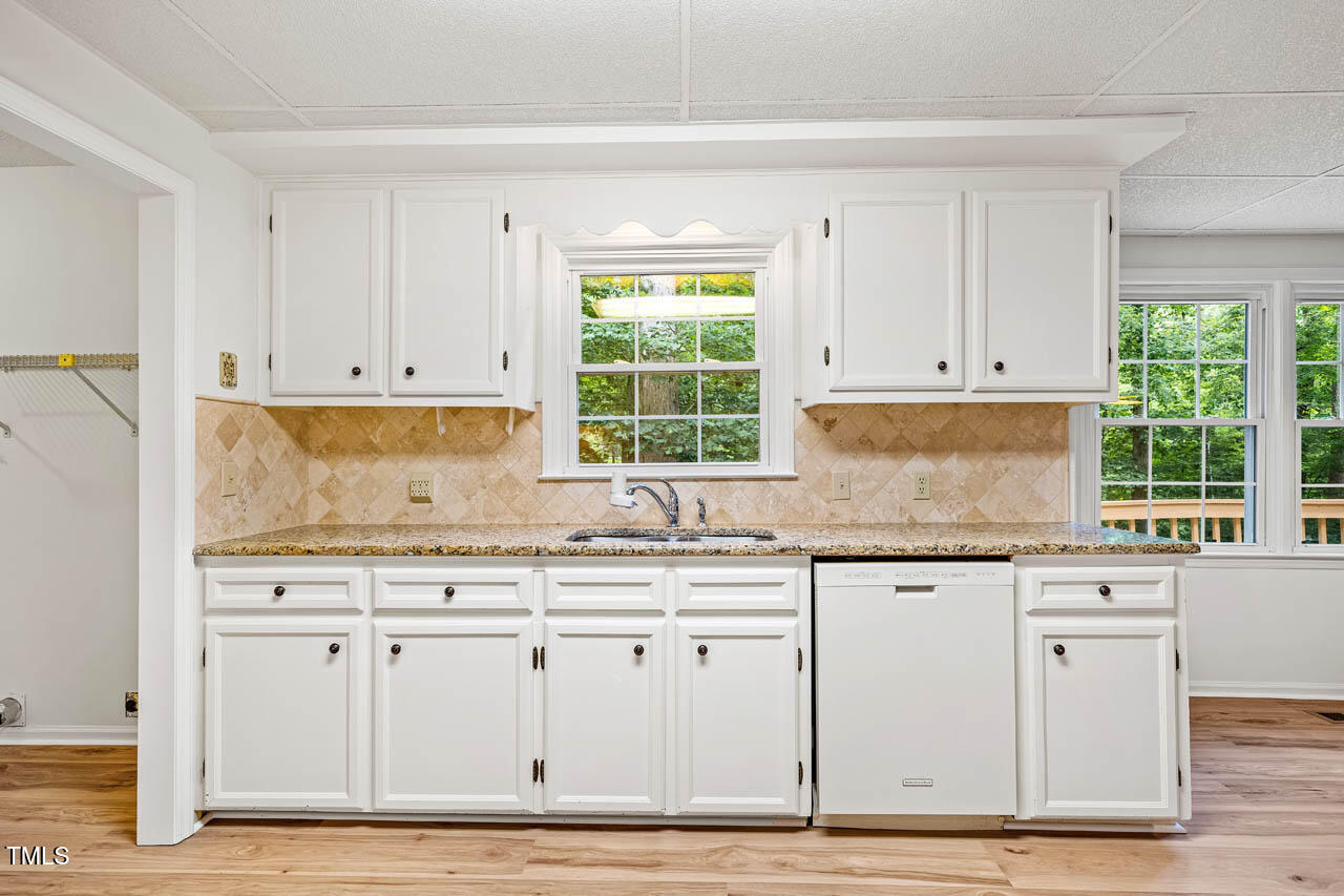 2330 Thunder Road Durham, NC 27712 - Photo 13 of 44 a kitchen with granite countertop white cabinets and a window