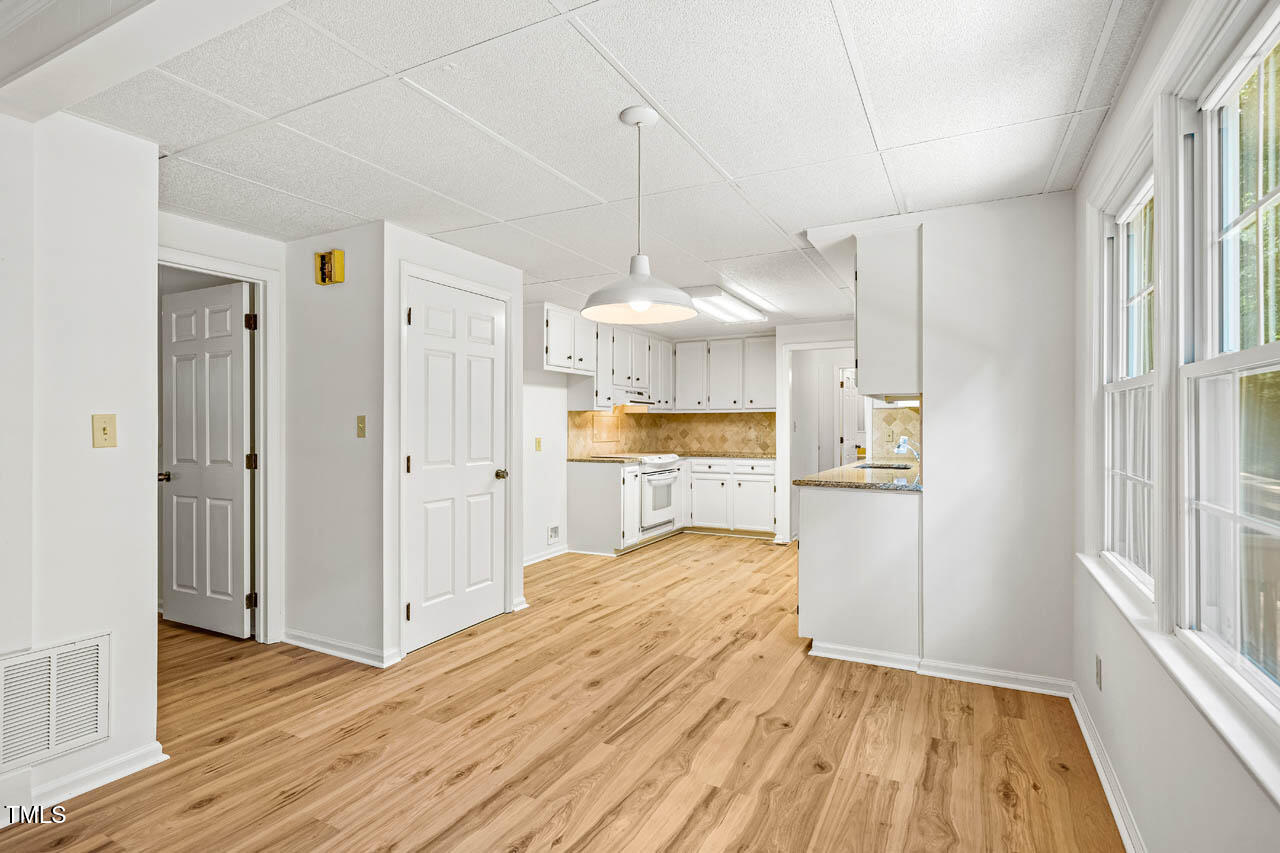 2330 Thunder Road Durham, NC 27712 - Photo 14 of 44 a view of a kitchen with wooden floor and a window