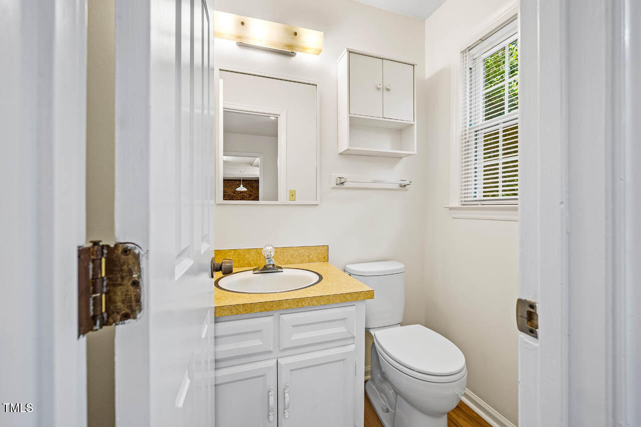 2330 Thunder Road Durham, NC 27712 - Photo 20 of 44 a bathroom with a sink toilet and mirror