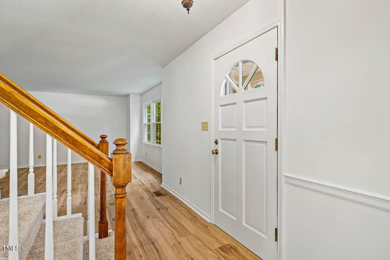 2330 Thunder Road Durham, NC 27712 - Photo 5 of 44 a view of hallway with stairs and wooden floor