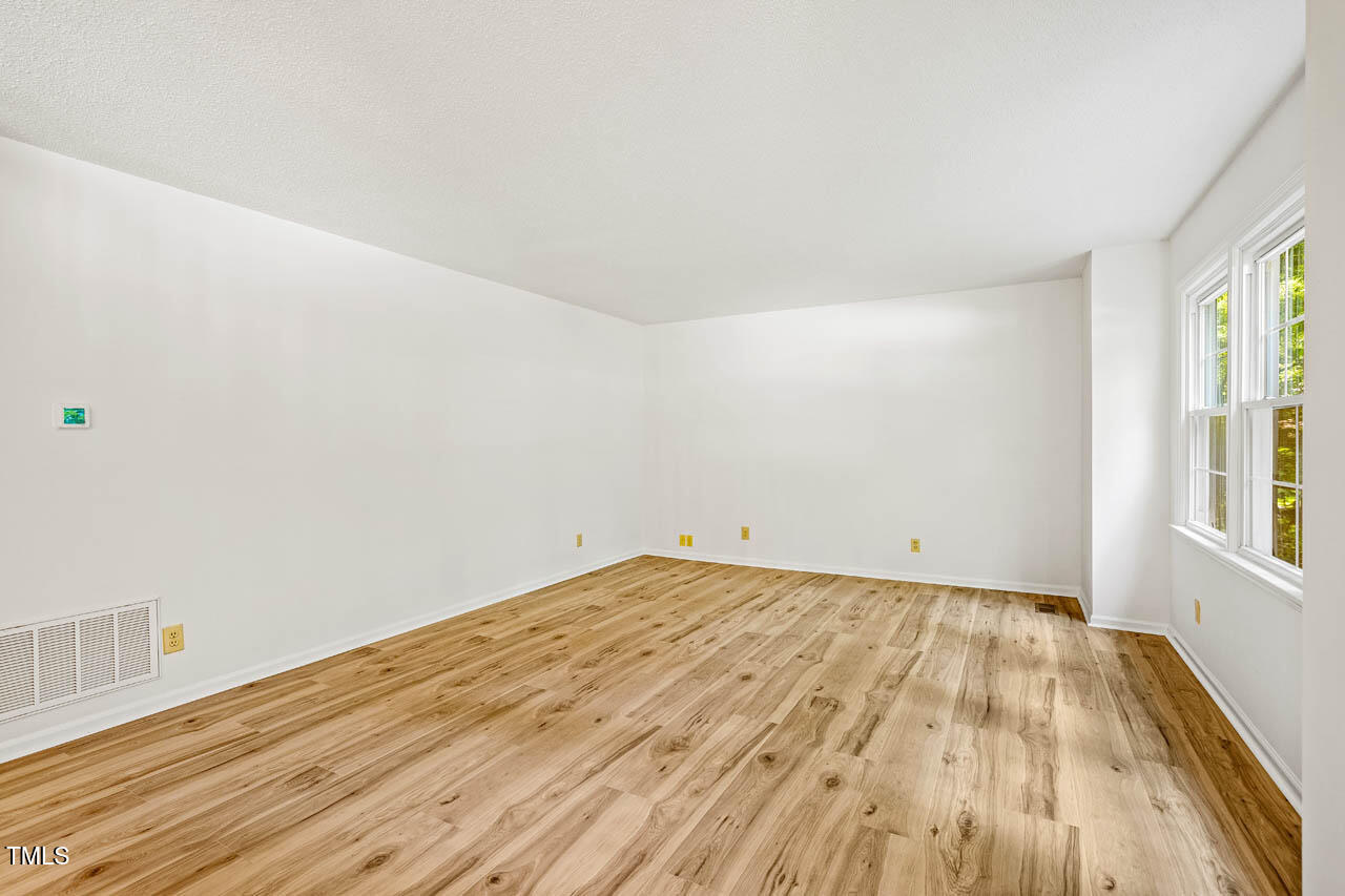 2330 Thunder Road Durham, NC 27712 - Photo 6 of 44 a view of empty room with wooden floor and fan