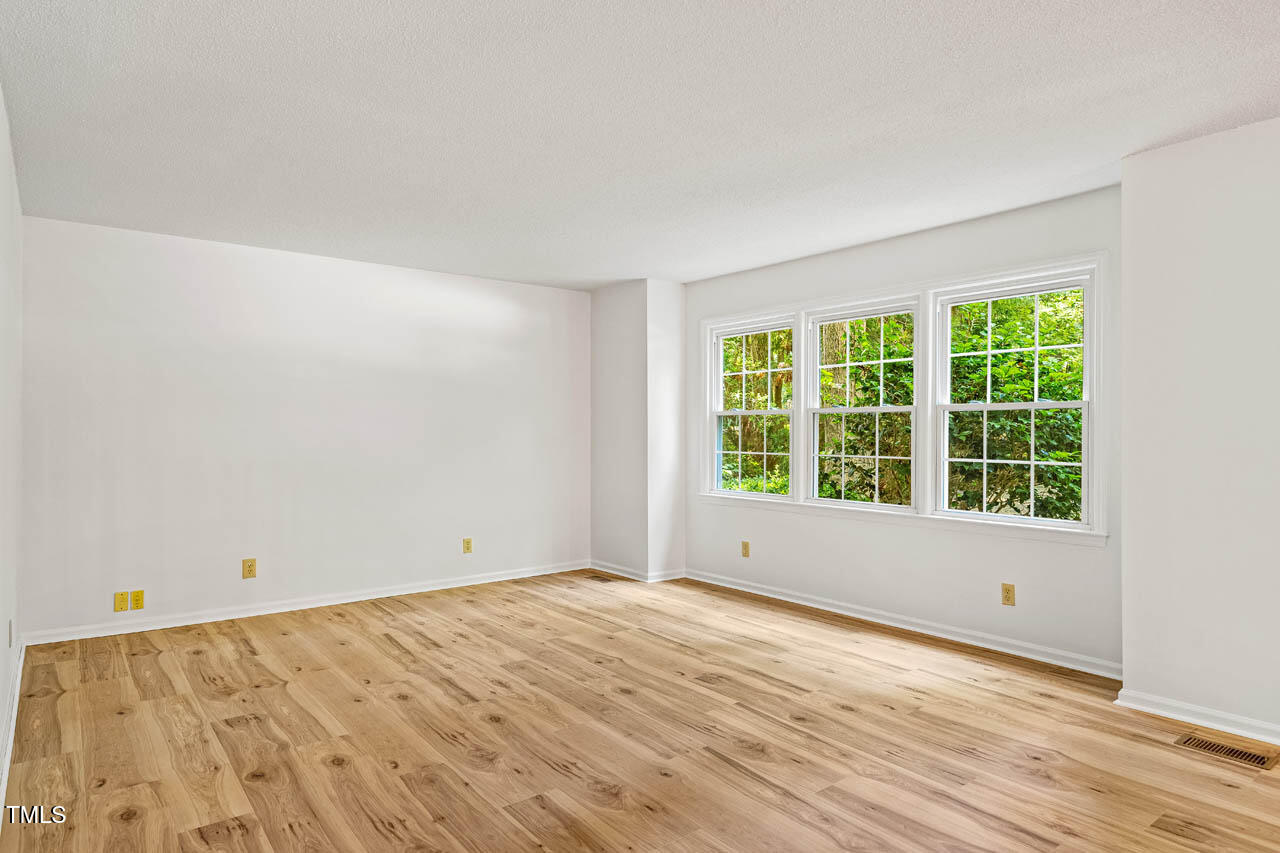 2330 Thunder Road Durham, NC 27712 - Photo 7 of 44 an empty room with wooden floor and windows