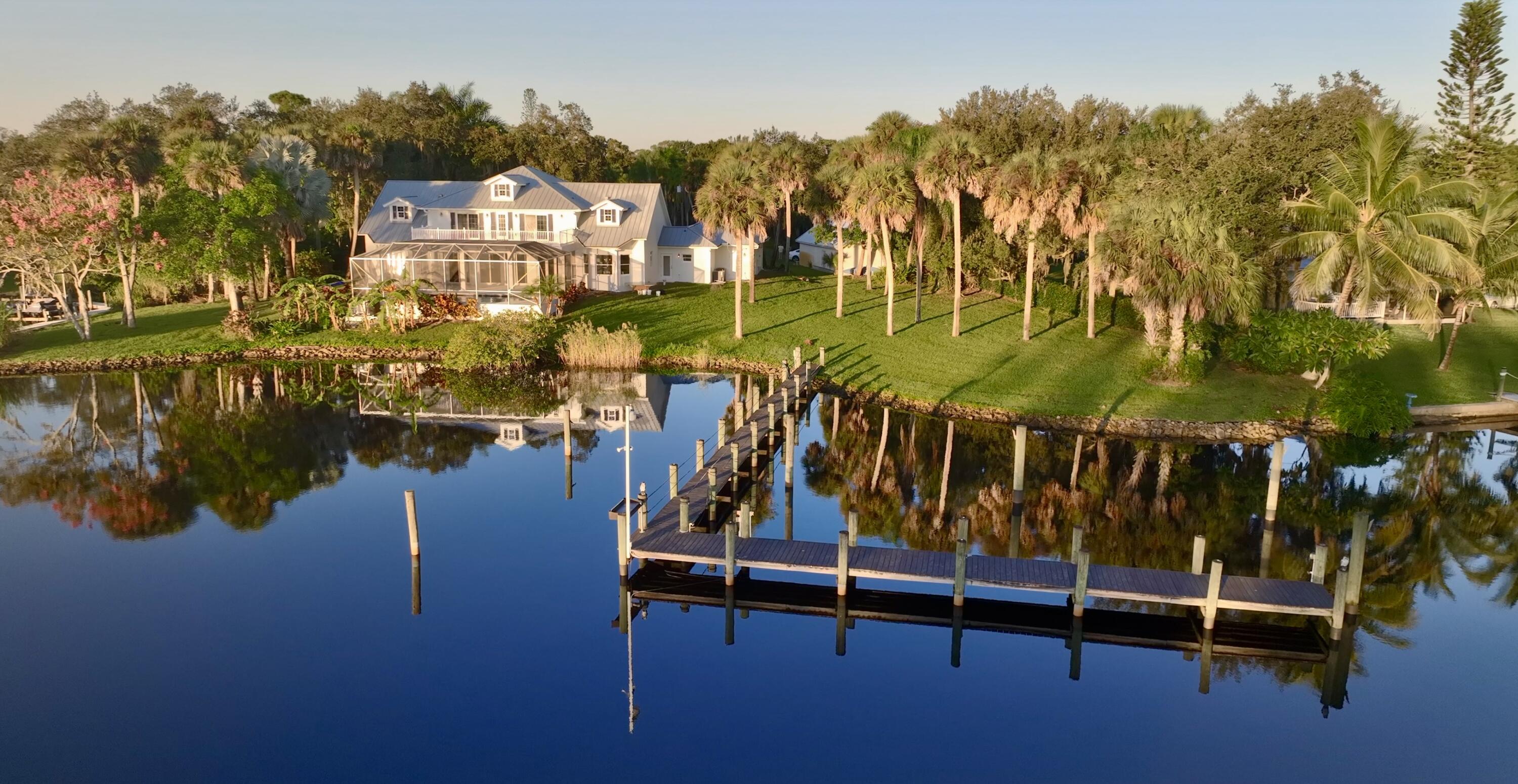 a view of swimming pool with outdoor seating and lake