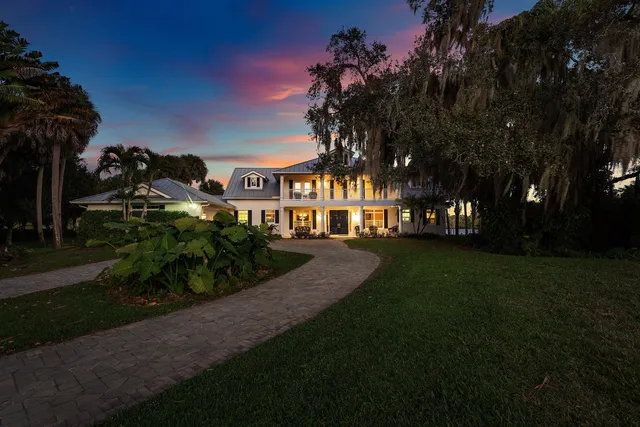 a front view of a residential houses with yard and green space