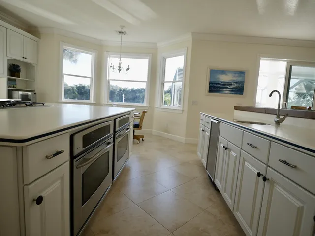 a kitchen with a sink stove and cabinets