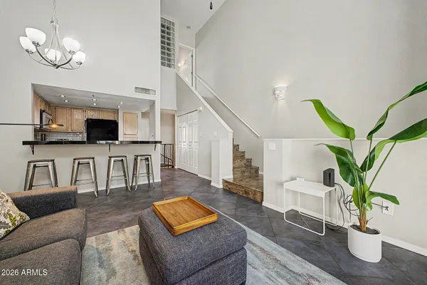 a living room with fireplace furniture and a potted plant