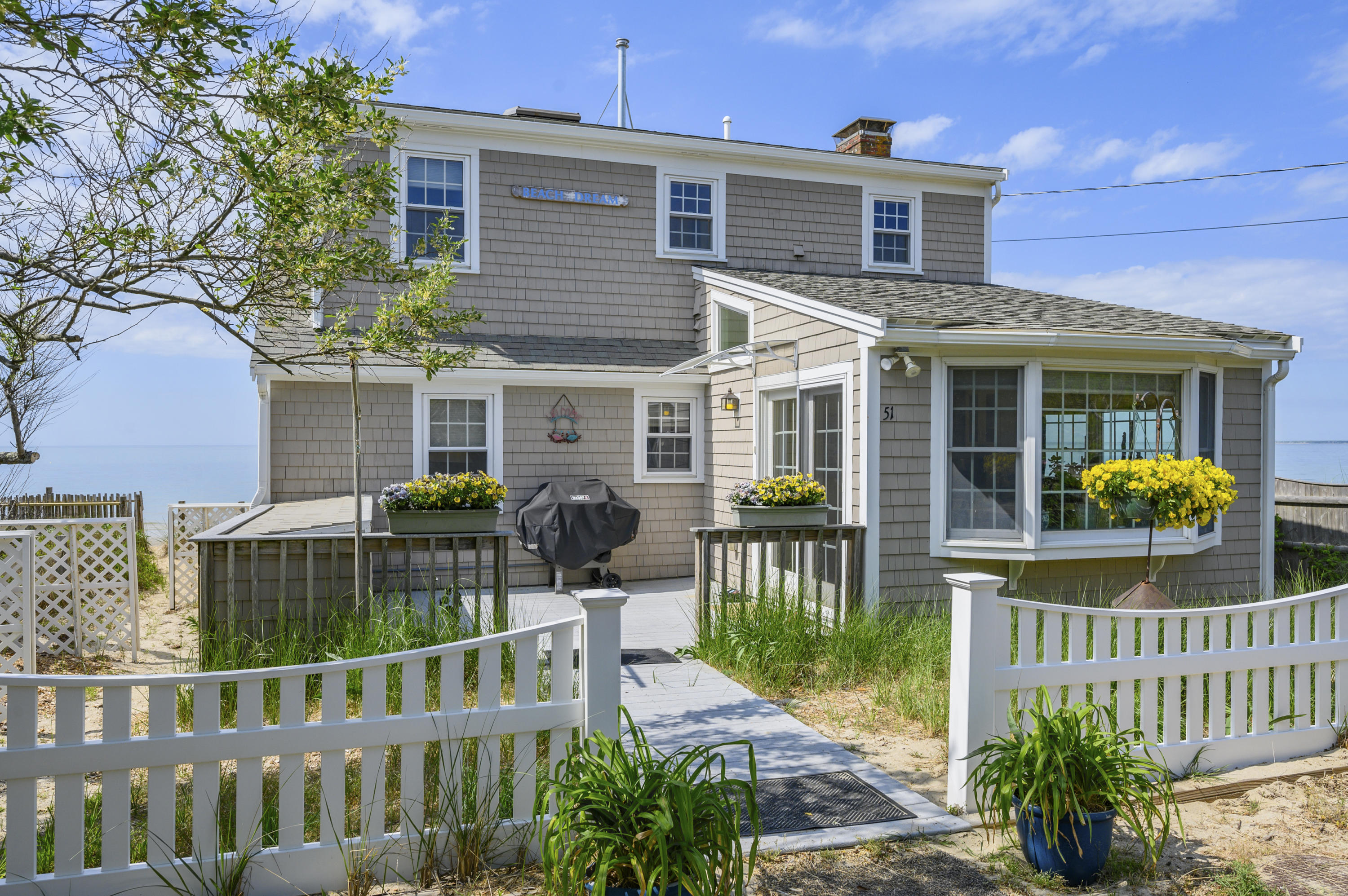 51 Captain Dunbar Road Brewster, MA 02631 - Photo 2 of 36 a front view of house with patio and garden