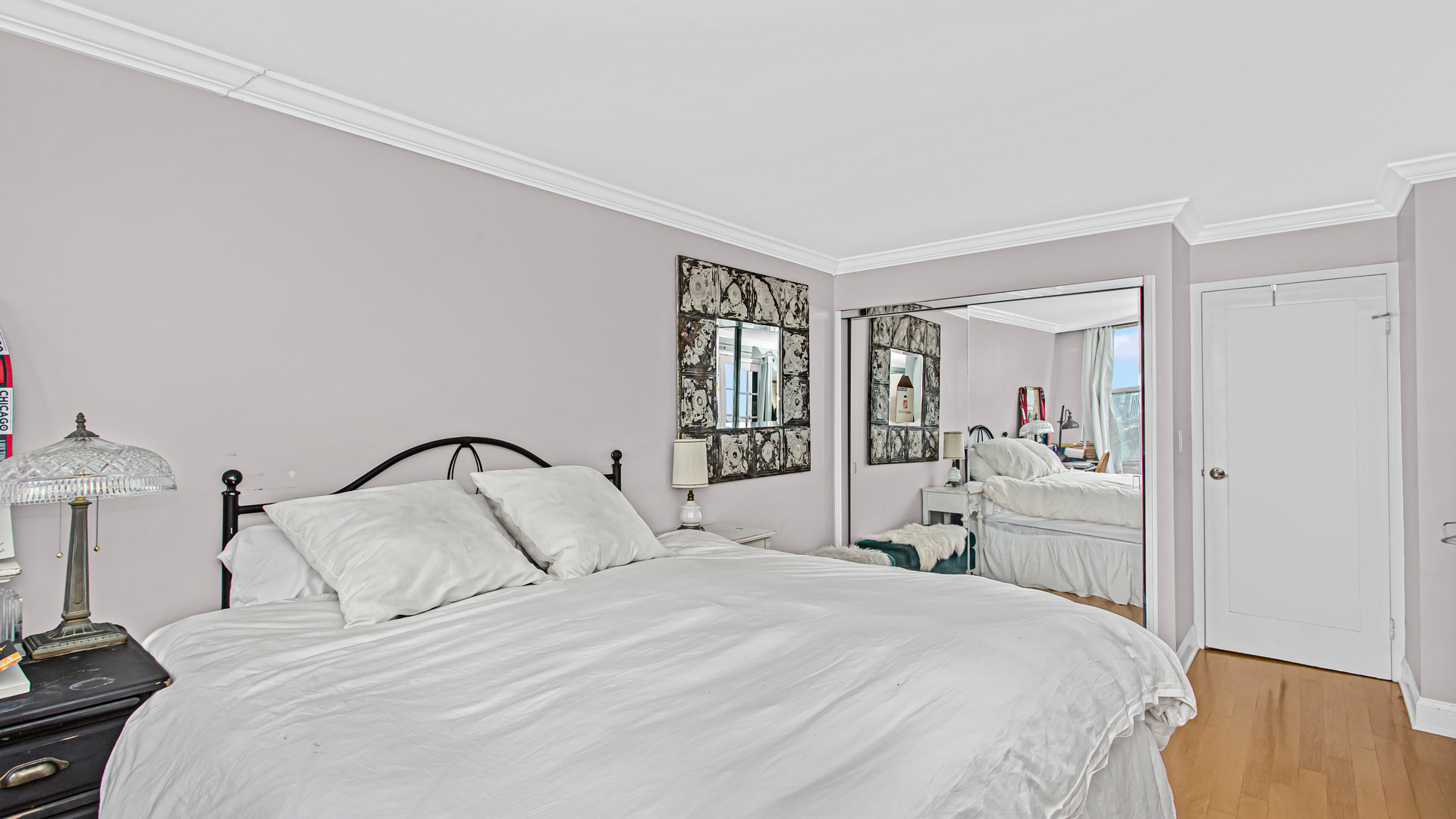 400 East Randolph Street, Unit 1915 Chicago, IL 60601 - Photo 12 of 25 a bedroom with a large bed and a closet