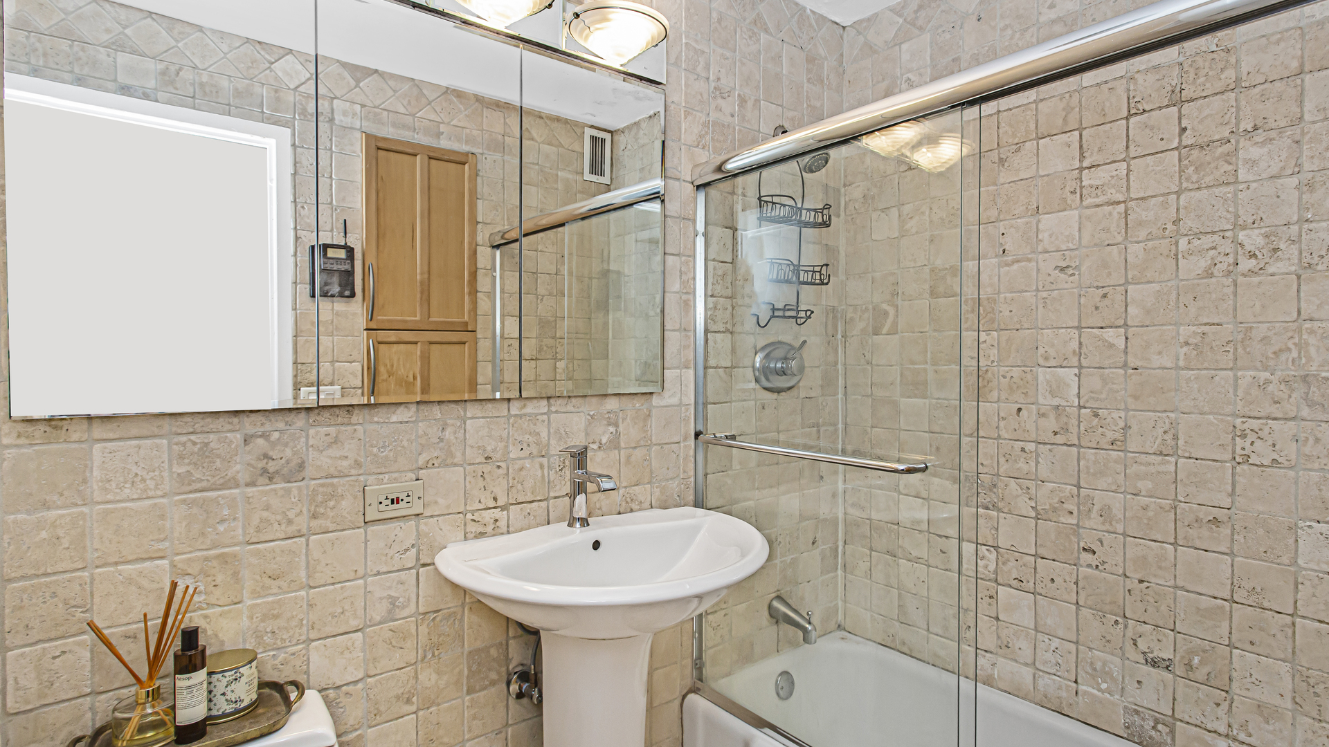 400 East Randolph Street, Unit 1915 Chicago, IL 60601 - Photo 13 of 25 a bathroom with a sink a toilet and shower