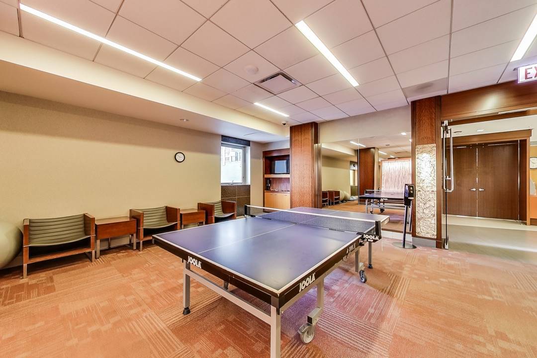 400 East Randolph Street, Unit 1915 Chicago, IL 60601 - Photo 17 of 25 a room with pool table and windows
