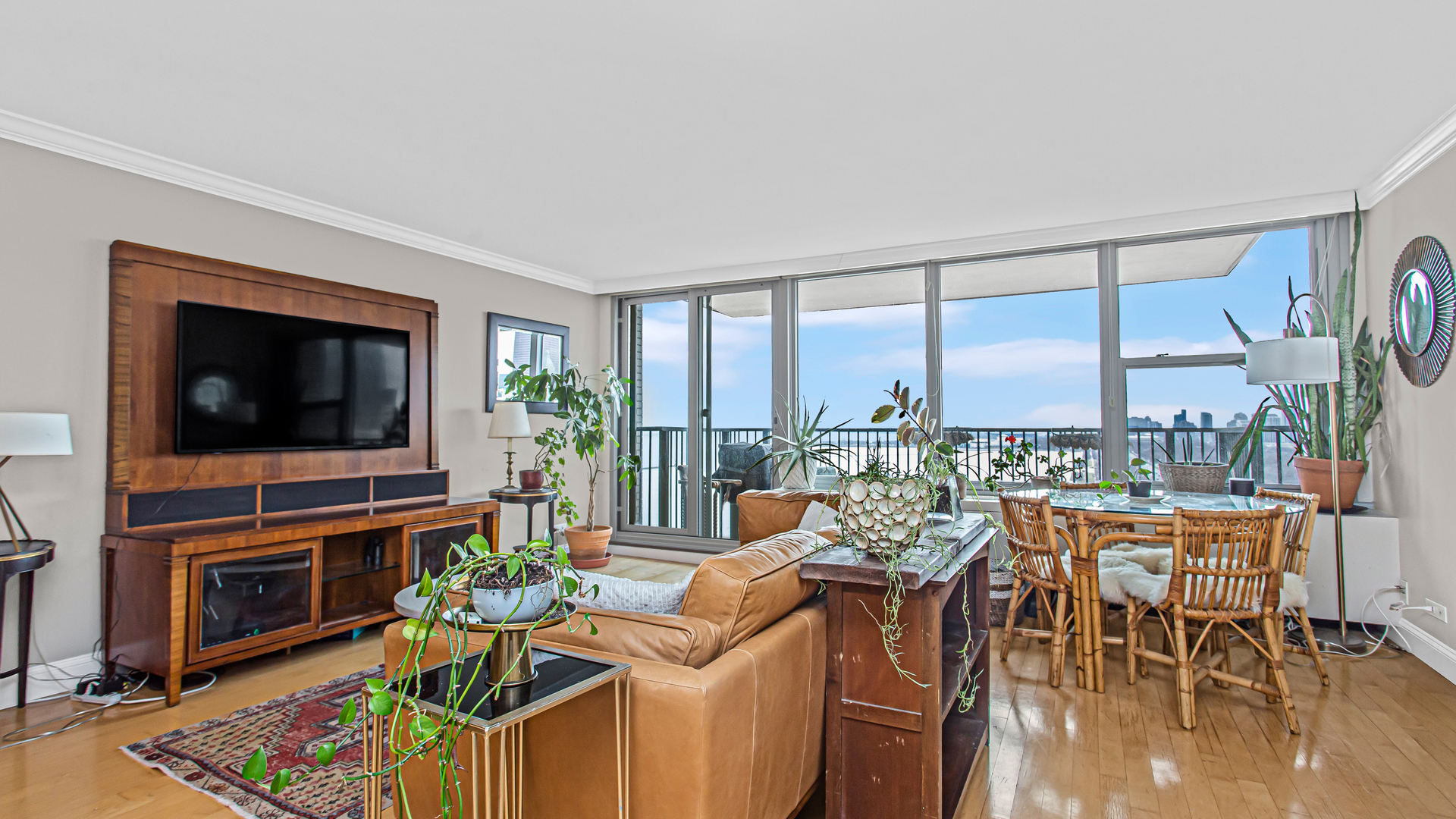 400 East Randolph Street, Unit 1915 Chicago, IL 60601 - Photo 7 of 25 a living room with furniture a flat screen tv and a floor to ceiling window