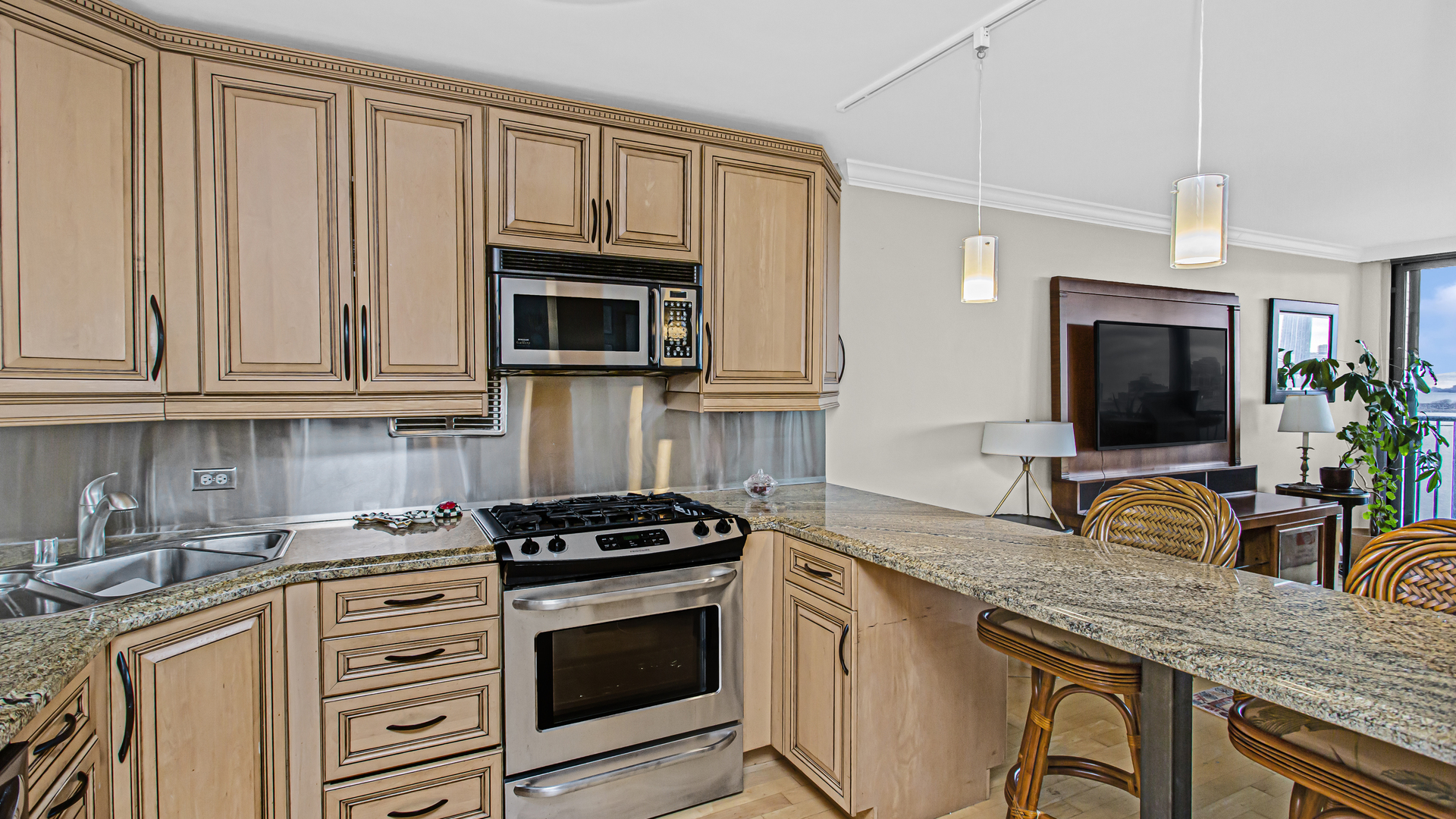 400 East Randolph Street, Unit 1915 Chicago, IL 60601 - Photo 9 of 25 a kitchen with granite countertop a stove top oven microwave and cabinets