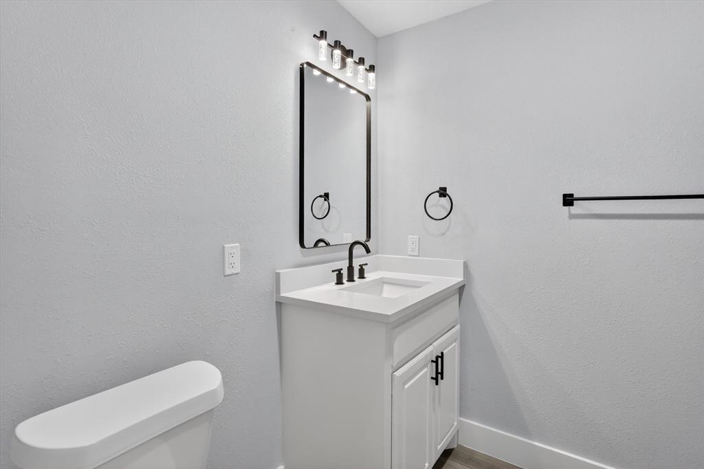 2005 Chestnut Road Carrollton, TX 75007 - Photo 19 of 35 a bathroom with a toilet sink and mirror