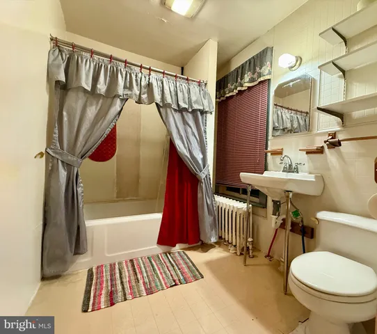 a bathroom with a sink a toilet and a bathtub