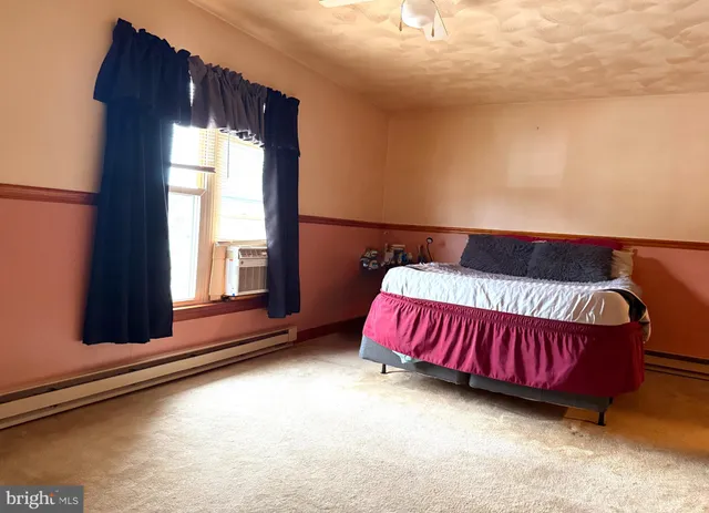 a bed sitting in a bedroom next to a window