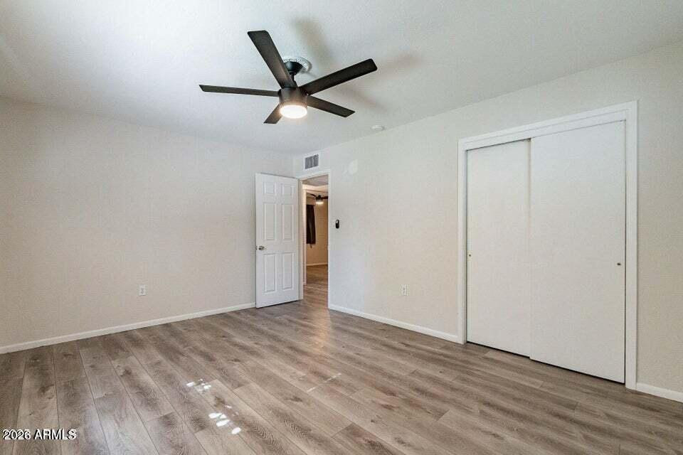 505 West Howe Street Tempe, AZ 85281 - Photo 11 of 20 an empty room with wooden floor and windows