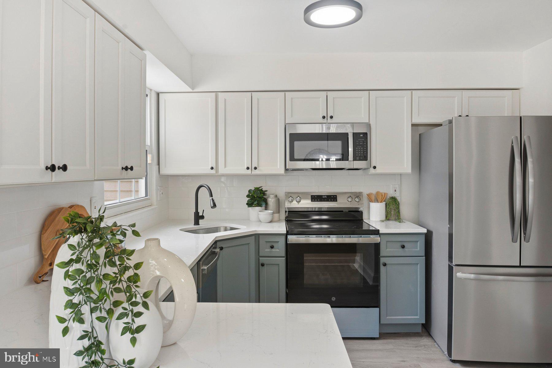 7 Prestwick Square Baltimore, MD 21228 - Photo 14 of 28 a kitchen with stainless steel appliances a refrigerator sink and white cabinets