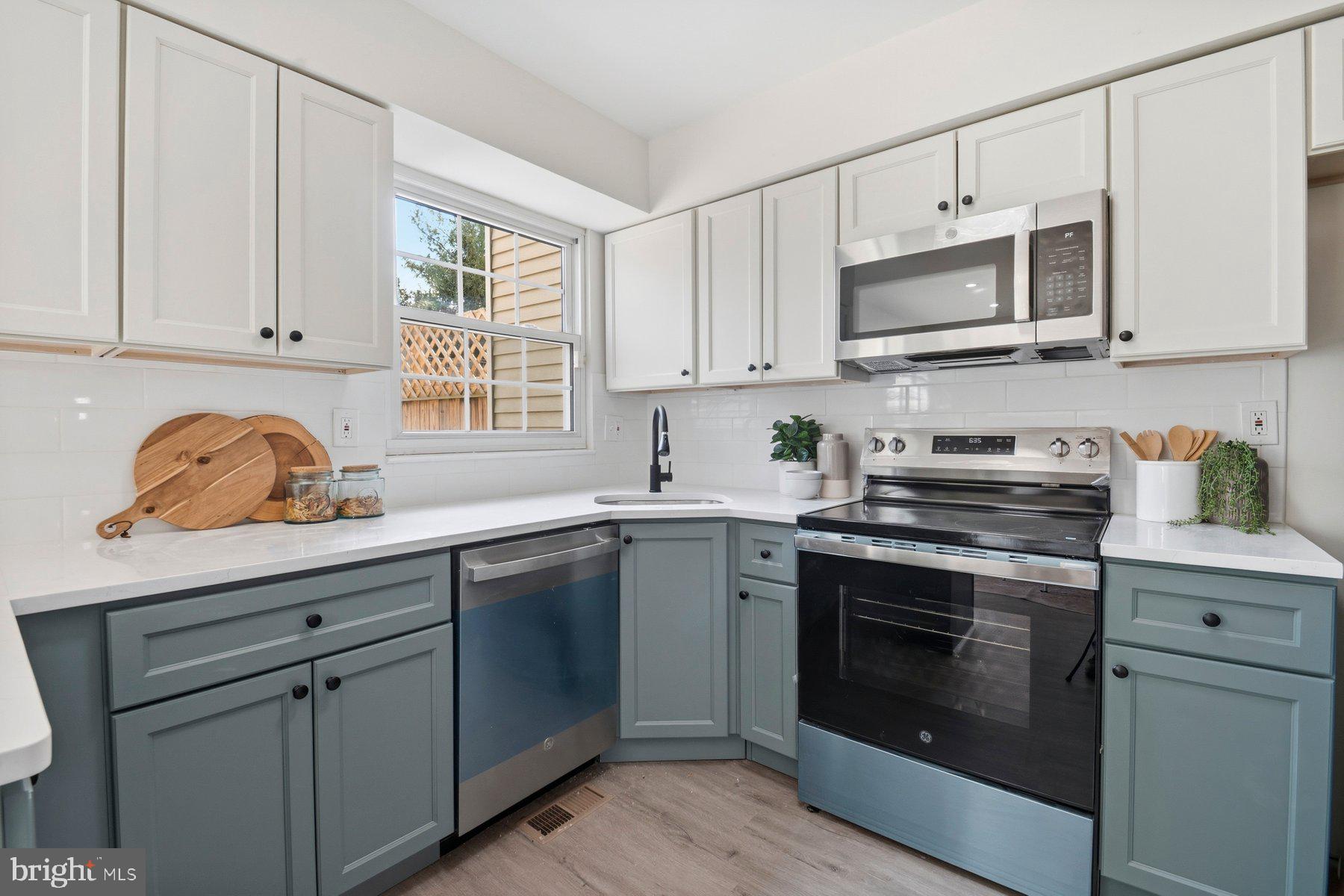 7 Prestwick Square Baltimore, MD 21228 - Photo 15 of 28 a kitchen with stainless steel appliances granite countertop white cabinets a sink and a stove