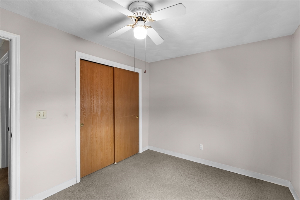 70 North Court Street, Unit F Fall River, MA 02720 - Photo 10 of 20 an empty room with chandelier fan
