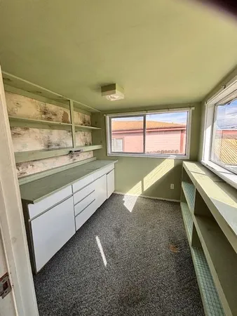 a view of a kitchen with a sink and windows