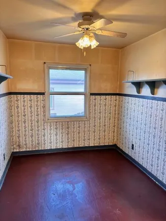 a view of a room with wooden floor and fan
