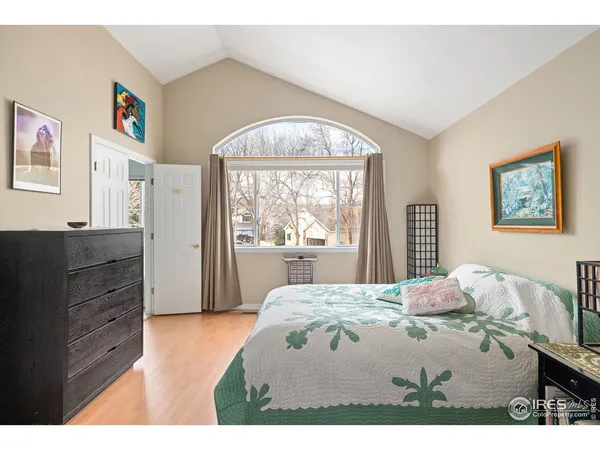 a bedroom with a bed window and a dresser