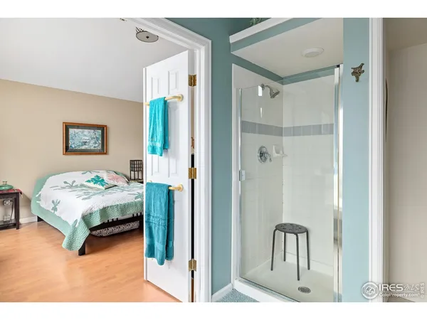 a bedroom with a bed and a painting on the wall