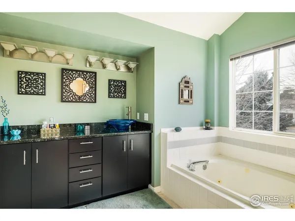 a bathroom with a bathtub and a window