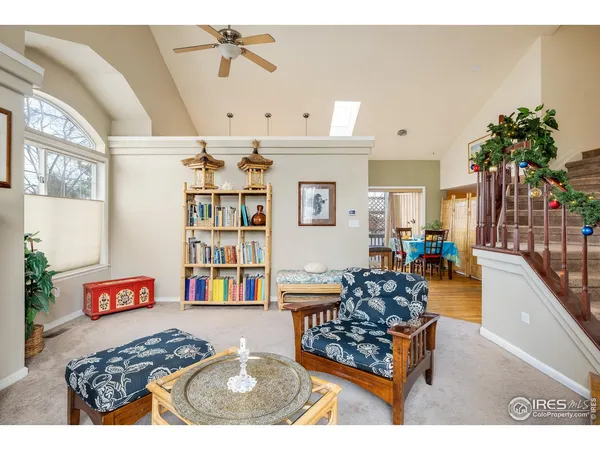 a living room with furniture and a book shelf