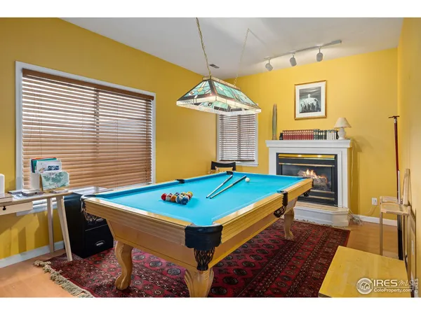 a room with pool table and windows