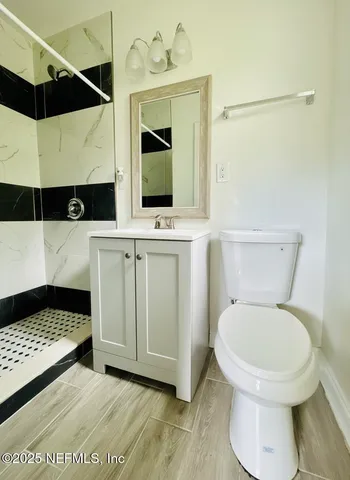 a bathroom with a sink toilet and shower