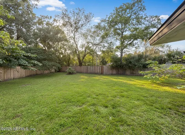 a view of outdoor space with deck and yard