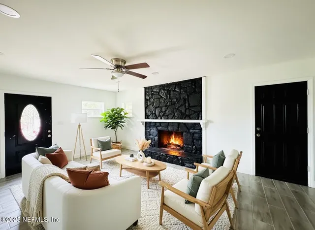 a living room with furniture a fireplace and a flat screen tv